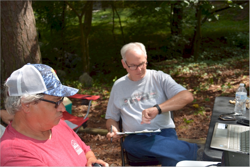 Phillip (KQ4ETC) checks the time for the log while Barry (W4NIC) keeps them coming in.
