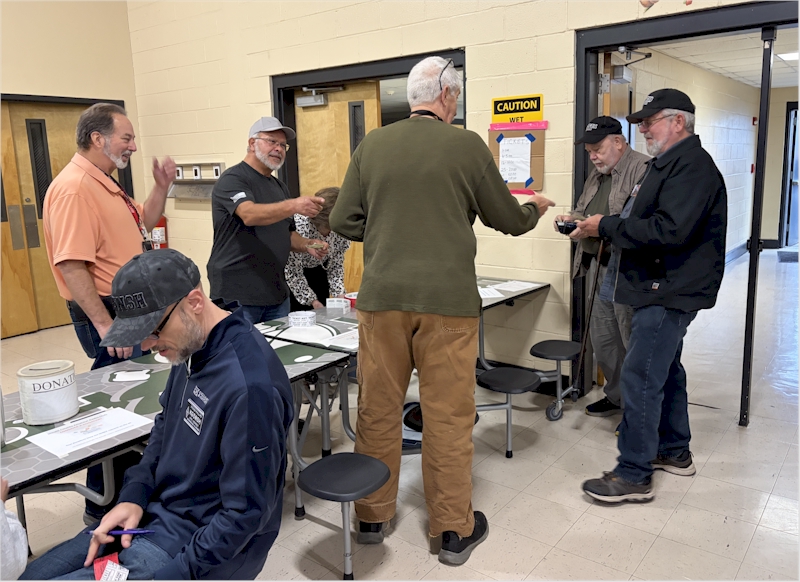 At the Gimme-Your-Money table